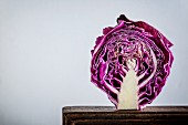 Half a red cabbage on a wooden board