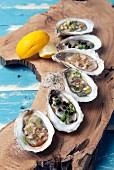 Assorted oysters on a plank of wood
