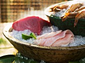 Sashimi in a wooden dish with crushed ice (Japan)