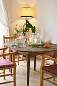 Place settings and candle lanterns on old wooden table