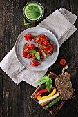 Italian tomato bruschetta with baked cherry tomatoes and sliced vegetables