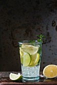 Homemade lemon and lime lemonade, served in glass with ice and fresh mint