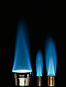 Blue flames of three bunsen burners