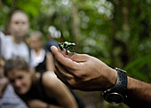 Man Holding Black Poison Frog