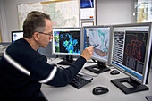 Meteorologist Evaluating Weather Maps