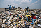 Girls Rummaging Through Landfill