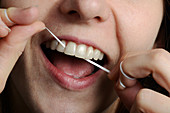 Woman Flossing her Teeth