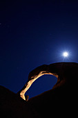 Moonrise over natural arch