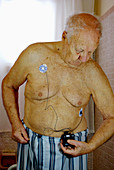 Elderly Man with Cardiac Event Recorder