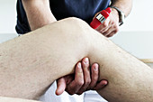 Orthopedist Examines a Patient's Knee