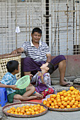 Burmese Father and Sons Selling Oranges