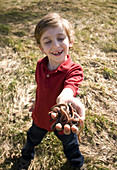 Young Boy with Worms in Hand