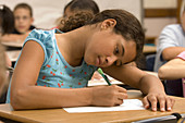 Young Student Writing in Class