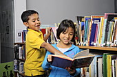 8 Year Old Boy and Girl in Library