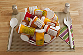 Bowl Filled with Pill Bottles on Table