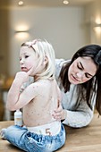 Mother treating daughter with chickenpox