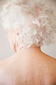 Elderly woman turning her head