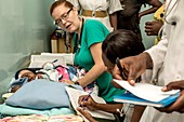 Hospital doctors examining babies