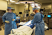 Surgeons preparing patient for surgery