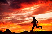 Man running against sunset