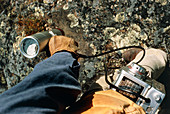 Geologist testing rocks with Geiger counter