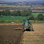 Tractor ploughing organic field