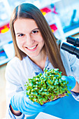 Female biologist holding seedlings
