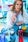 Scientist testing food samples in a flask
