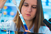 Scientist using pipette and a test tube
