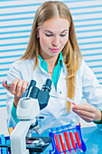 Lab assistant using pipette