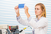 Technician holding thin film solar cells