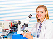 Technician with microscope,portrait