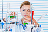 Female chemist pouring chemicals