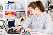 Female electrical engineer using laptop