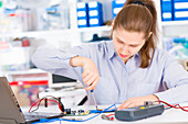 Female electrical engineer testing