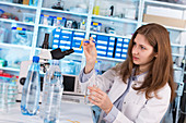 Lab technician testing water in lab