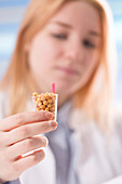 Lab technician holding legumes