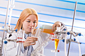 Lab technician pouring chemical