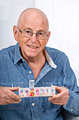 Man with pill organiser