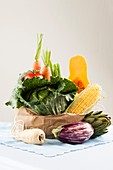 Fresh vegetables in brown paper bag