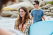 Woman on beach with surfboard