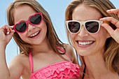 Mother and daughter wearing sunglasses
