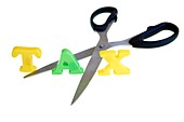 Scissors cutting the word Tax