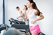 Man and women exercising in gym