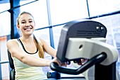 Young woman exercising on exercise bike