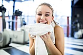 Woman holding towel after exercising