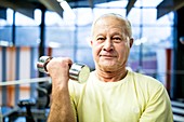 Senior man holding dumbbell