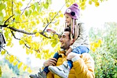 Father and daughter looking at branch