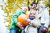 Children holding pumpkin