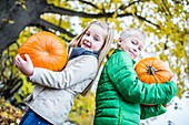 Children holding pumpkin